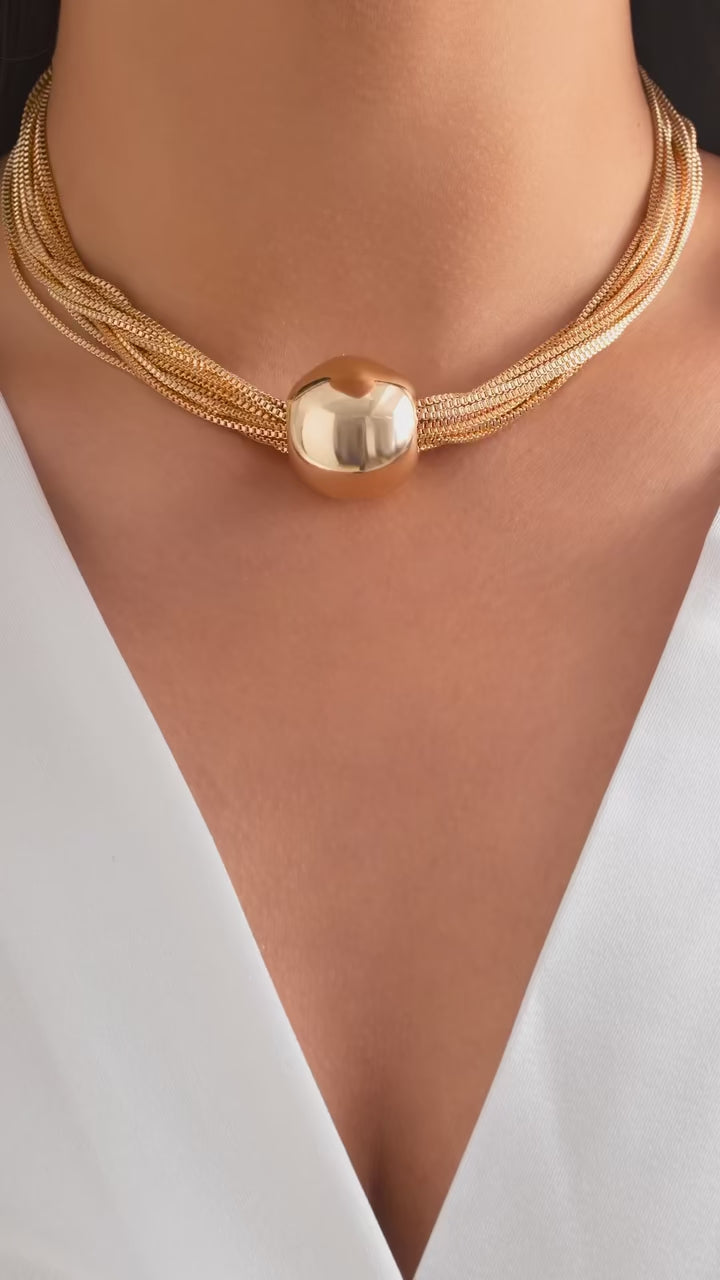 Close-up of the ZÜRVRA Twisted Link ensemble in gold and silver, showing the intricate exaggerated chunky chain texture of the necklace and matching bracelet.