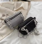 The Radiant Cylinder — Artisan Strass Edition in Midnight Black featuring a silver geometric chain. The video showcases the light-reflecting crystals and architectural silhouette against a classic neutral ensemble.