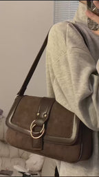 Detailed view of the ZÜRVRA Vintage Suede Shoulder Bag in Umber Brown and Stained Coffee, showcasing the soft suede texture and the signature double-ring gold clasp.