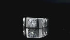 Close-up of the ZÜRVRA Sovereign Square adjustable men's ring in artisan platinum finish with a square-cut emerald green crystal.